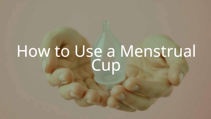 A clear menstrual cup held in clean hands, soft pink background, realistic and hygienic, modern feminine care product.
